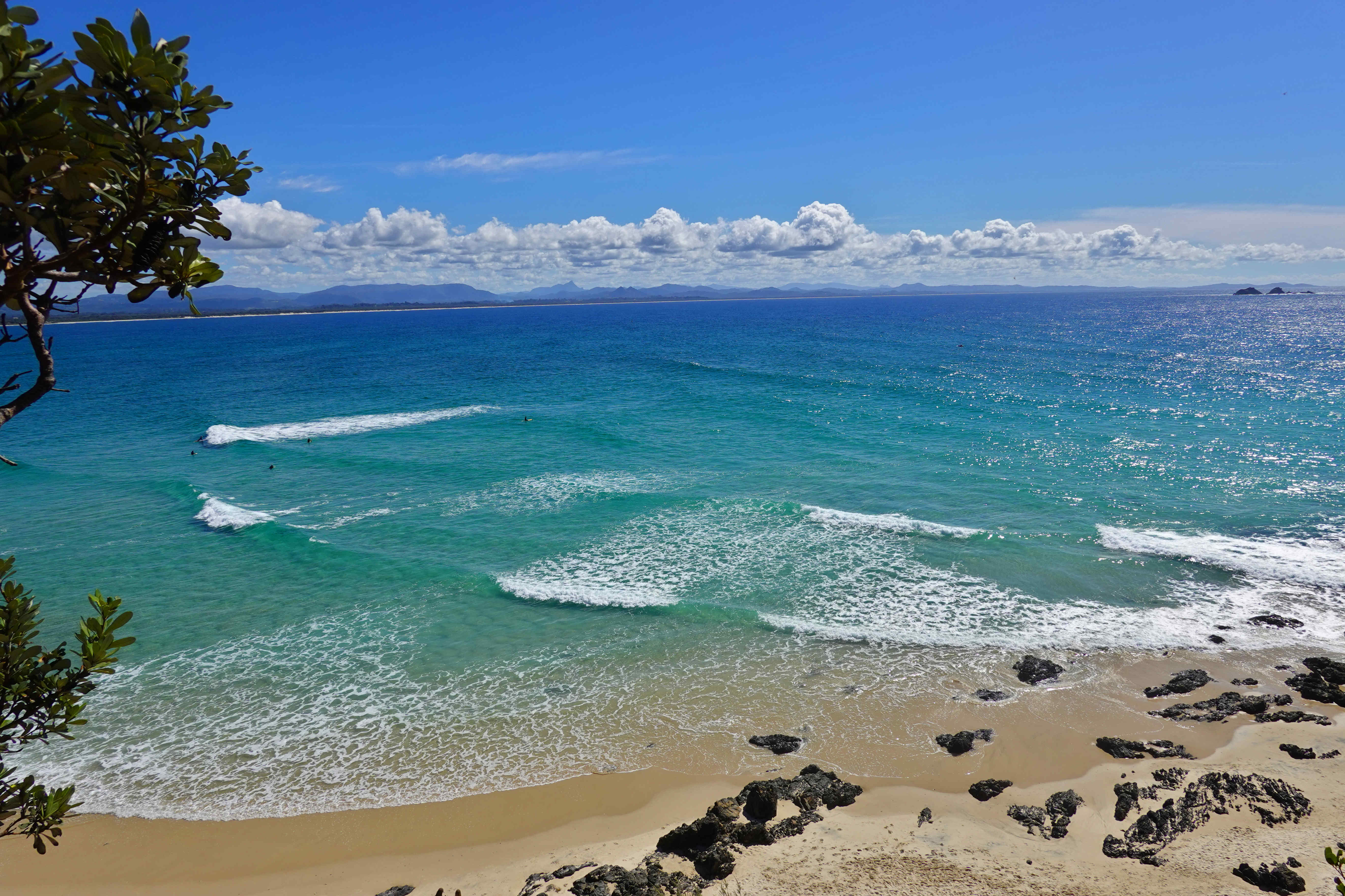 Sparkling ocean, low clouds, colourful waters of Wategos Beach, Australia
